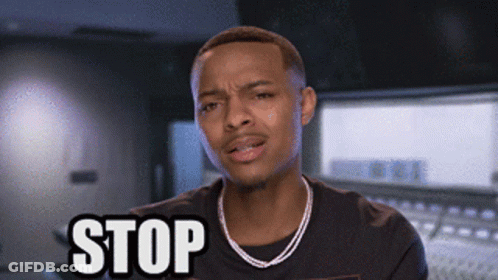 A Man Wearing A Necklace And A Black Shirt Is Saying Stop GIF