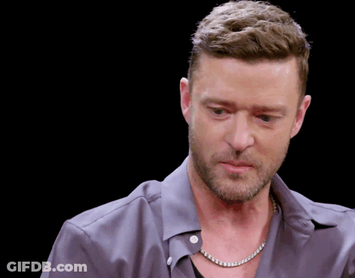 A Man Wearing A Necklace And A Grey Shirt GIF