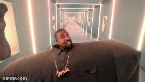A Man Wearing A Necklace That Says ' Kanye West ' On It GIF