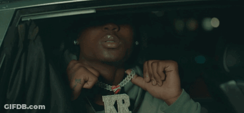A Man Wearing A Necklace With A Letter R On It GIF