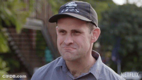 A Man Wearing A Netflix Hat Is Making A Face GIF