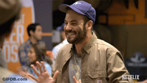 Man Smiling In Netflix Jacket And Hat GIF