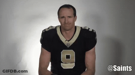 A Man Wearing A New Orleans Saints Jersey Is Making A Face . GIF