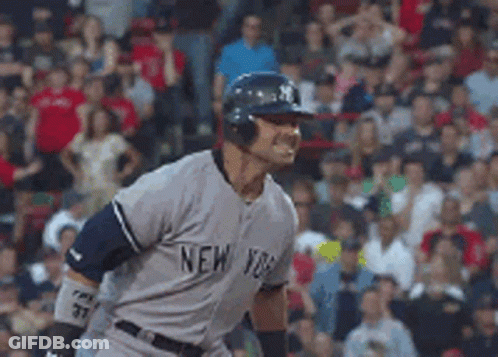 A Man Wearing A New York Jersey Is Standing In Front Of A Crowd GIF