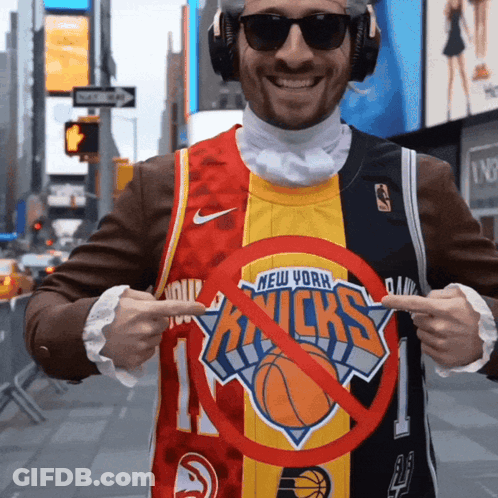 A Man Wearing A New York Knicks Jersey Points To A Red Circle GIF