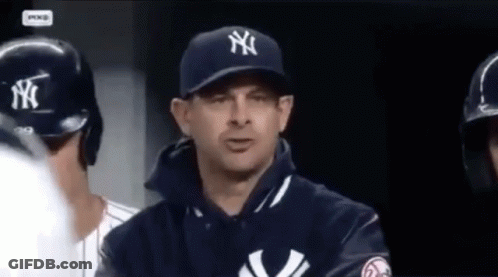 A Man Wearing A New York Yankees Hat And Jacket GIF