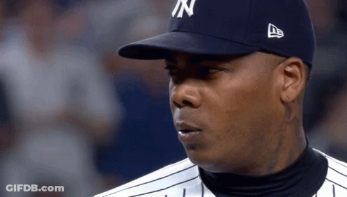 A Man Wearing A New York Yankees Hat Looks At Something GIF