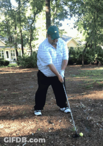 A Man Wearing A Nike Hat Is Swinging A Golf Club At A Golf Ball GIF