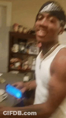 A Man Wearing A Nike Headband Is Holding A Cell Phone In His Hand GIF