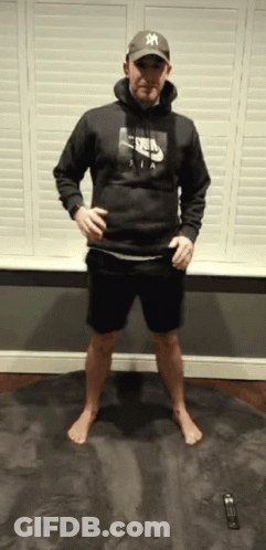 A Man Wearing A Nike Hoodie And A Ny Hat GIF