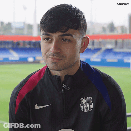 A Man Wearing A Nike Jacket With A Fcb Logo On The Front GIF