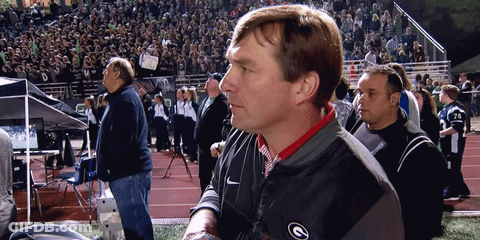 A Man Wearing A Nike Jacket With The Letter G On The Front GIF