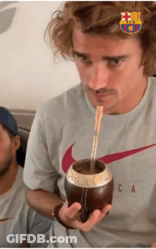 A Man Wearing A Nike Shirt Drinks From A Cup With A Straw GIF