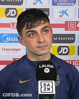 A Man Wearing A Nike Shirt Is Talking Into A Laliga Microphone . GIF
