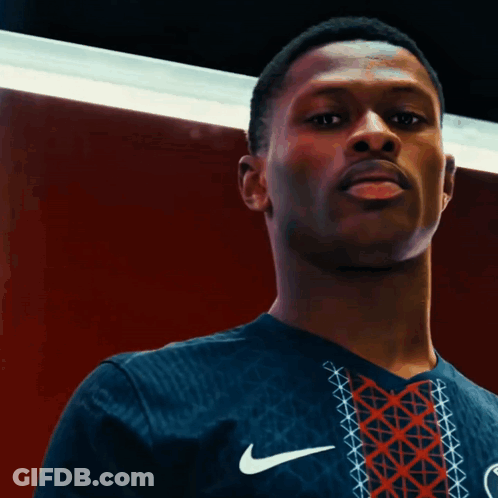 A Man Wearing A Nike Shirt That Says Paris GIF