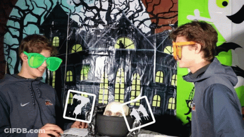 A Man Wearing A Nike Sweatshirt Is Standing Next To Another Man Wearing Green Glasses GIF