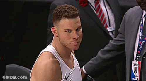 A Man Wearing A Nike Tank Top Is Sitting In A Chair GIF