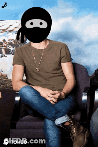 A Man Wearing A Ninja Mask Is Sitting In A Chair With The Word Tokeo Below Him GIF