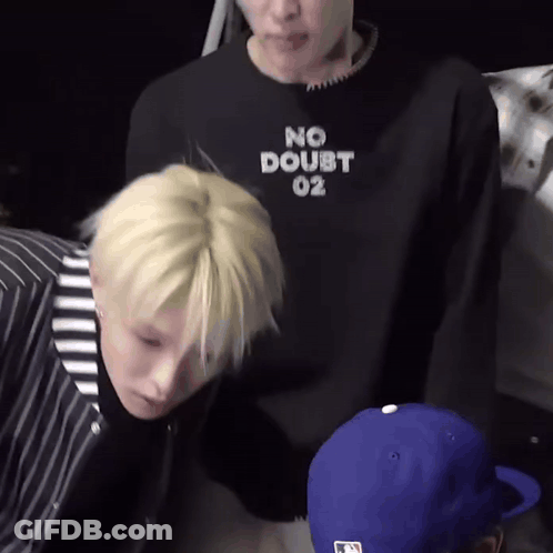 A Man Wearing A No Doubt 02 Sweatshirt Is Standing Next To Another Man GIF