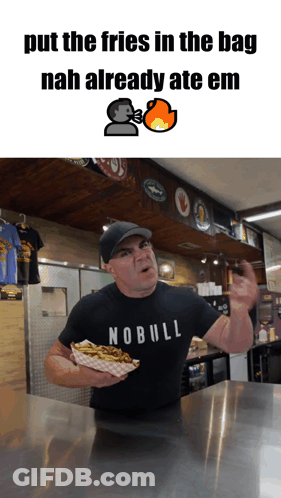 A Man Wearing A Nobull Shirt Is Holding A Tray Of French Fries GIF