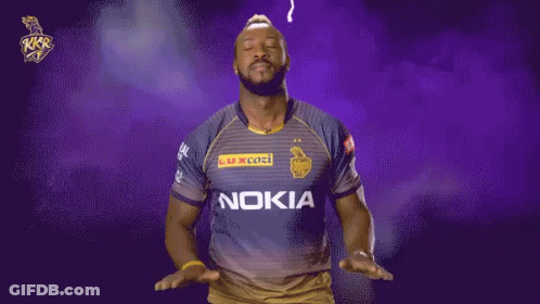 A Man Wearing A Nokia Shirt Stands In Front Of A Purple And Yellow Background GIF