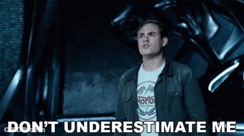 A Man Wearing A Norton Shirt Is Standing In Front Of A Machine GIF