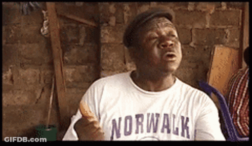 A Man Wearing A Norwalk Shirt Holds A Sandwich GIF