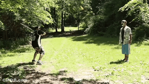 A Man Wearing A Number 10 Jersey Is Swinging A Baseball Bat GIF