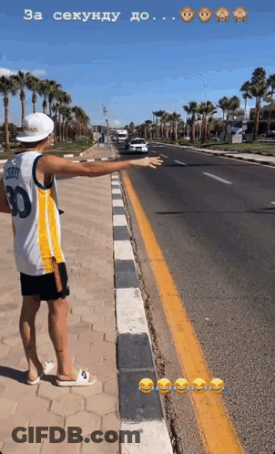 A Man Wearing A Number 30 Jersey Is Standing On The Side Of A Road GIF