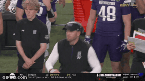 A Man Wearing A Number 48 Jersey Stands On A Football Field GIF