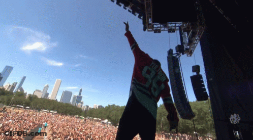 A Man Wearing A Number 98 Jersey Stands On Stage GIF