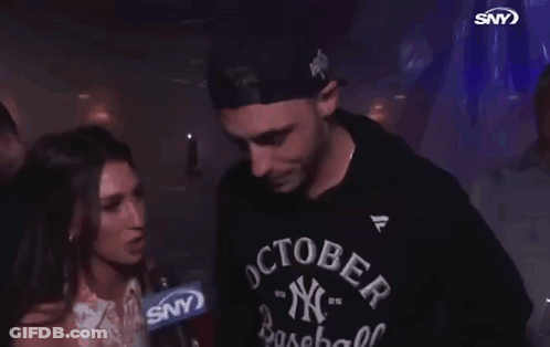 A Man Wearing A Ny Baseball Shirt Is Being Interviewed GIF