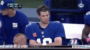 A Man Wearing A Ny Giants Jersey Sits In The Stands GIF