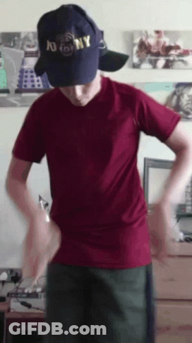 A Man Wearing A Ny Hat And A Red Shirt GIF