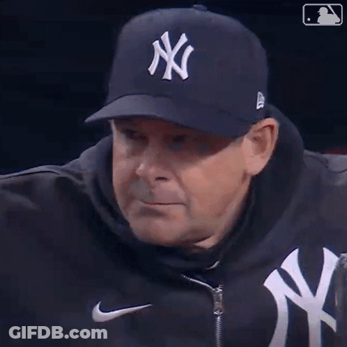 A Man Wearing A Ny Yankees Hat And A Nike Jacket GIF