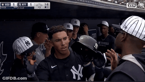 A Man Wearing A Ny Yankees Jersey Stands In A Dugout GIF