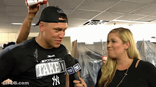 A Man Wearing A Ny Yankees Shirt Is Interviewed By A Woman GIF