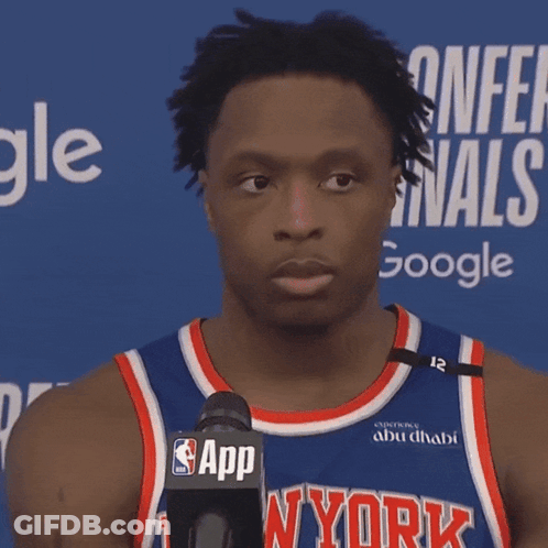 A Man Wearing A Ny York Jersey Stands In Front Of A Microphone GIF
