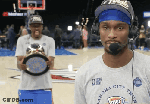 A Man Wearing A Oklahoma City Thunder T-Shirt Holds A Trophy GIF