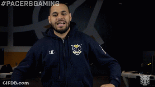 A Man Wearing A Pacers Gaming Hoodie Stands In Front Of A Black Background GIF
