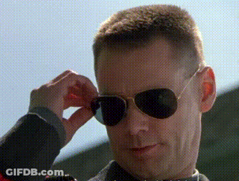 A Man Wearing A Pair Of Aviator Sunglasses Adjusts His Glasses GIF