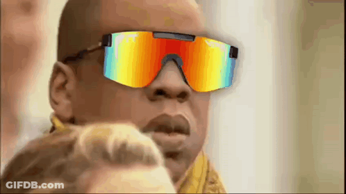 A Man Wearing A Pair Of Colorful Sunglasses Is Looking At A Woman . GIF