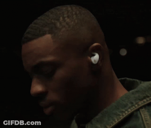 A Man Wearing A Pair Of Ear Buds With The Letter O On Them GIF