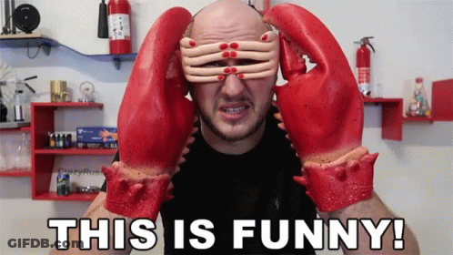 A Man Wearing A Pair Of Lobster Gloves Covering His Eyes GIF