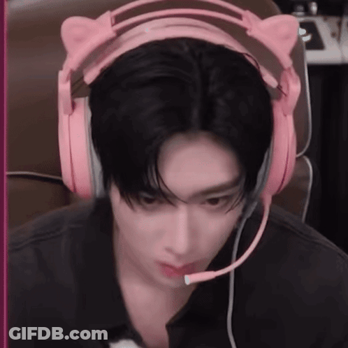 A Man Wearing A Pair Of Pink Headphones With A Microphone . GIF