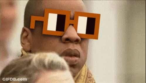 A Man Wearing A Pair Of Square Glasses With The Letter H On It GIF
