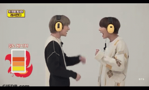 A Man Wearing A Pair Of Yellow Headphones Has His Mouth Open GIF