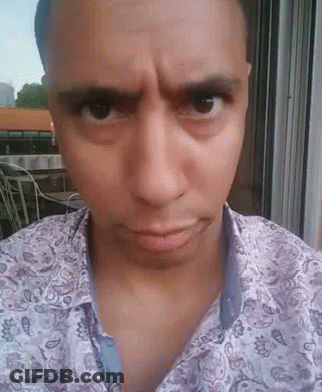 A Man Wearing A Paisley Shirt Looks At The Camera With A Serious Look On His Face GIF