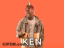 A Man Wearing A Party Hat Is Standing In Front Of A Red Background And Says `` Birthday Ken '' . GIF