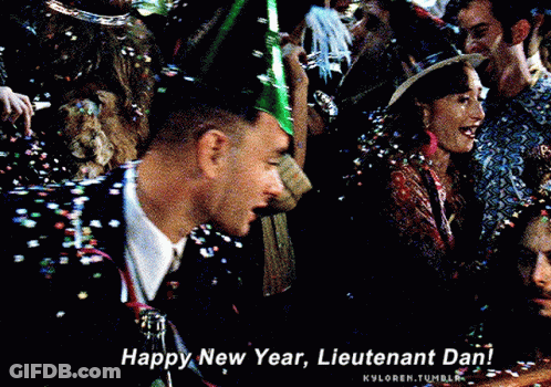 A Man Wearing A Party Hat Is Surrounded By Confetti And Says Happy New Year Lieutenant Dan GIF